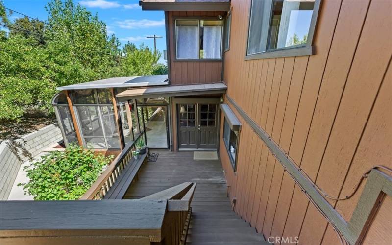 UPPER DECK TO FRENCH DOORS INTO THE DINING ROOM AND ENTRANCE INTO THE SUNROOM