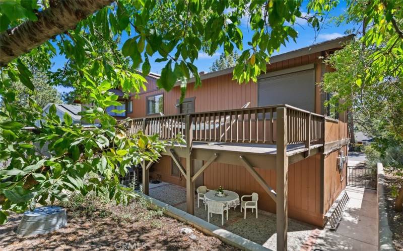 BACK OF HOME THAT SHOWS THE UPPER DECK AND PRIVATE PATIO. NOTE HOME IS FENCED AND GATED WITH RETAINING WALL.