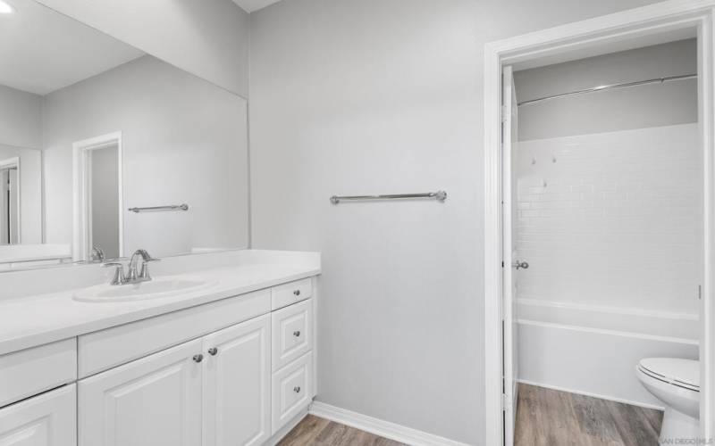 Bathroom with dual vanities and tub / shower combo to service both upstairs guest rooms