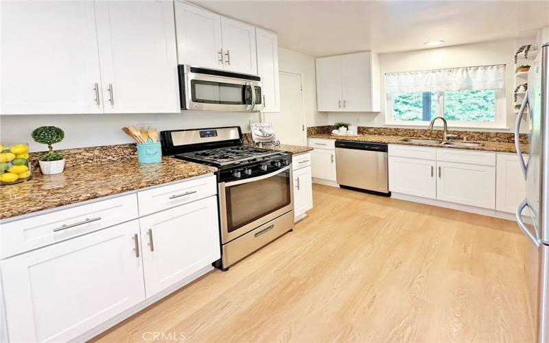 Enjoy gourmet cooking with the gas stove as well as the many other stainless appliances in your remodeled kitchen