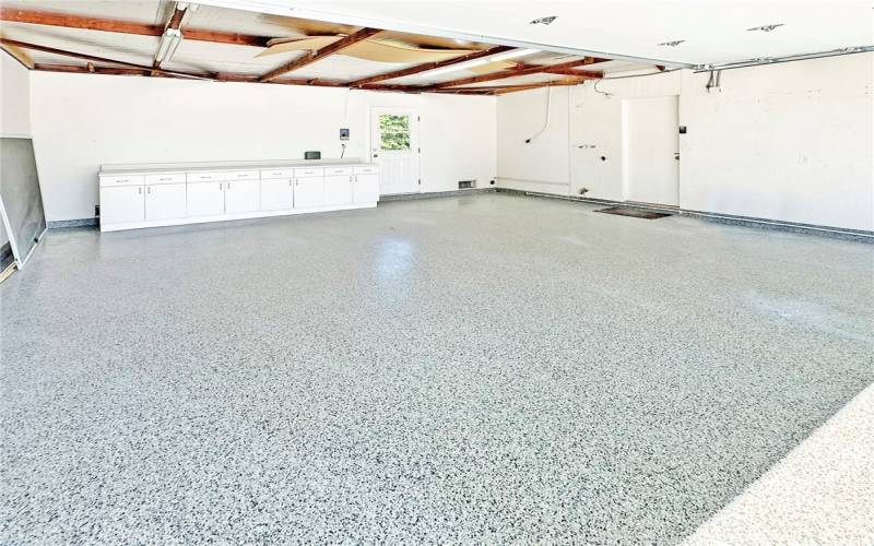 Epoxy flooring and storage cabinets in garage