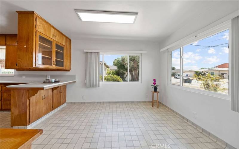 Bright dining room off the kitchen looks out to front and driveway