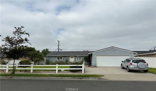 Front view includes beautiful durable vinyl fencing and large front yard