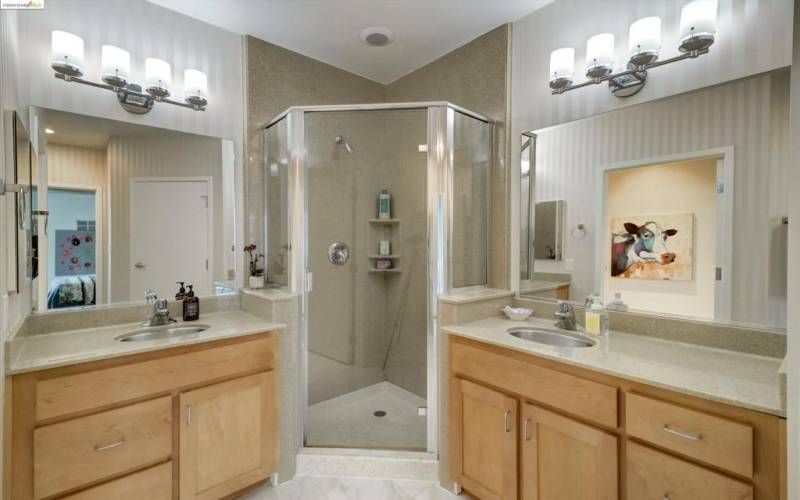 Separated vanities walk-in closet in primary bath