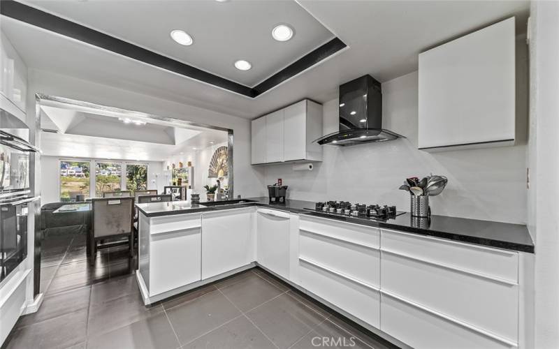 Modern, updated kitchen with stainless steel appliances, European cabinets with a self-closing drawers