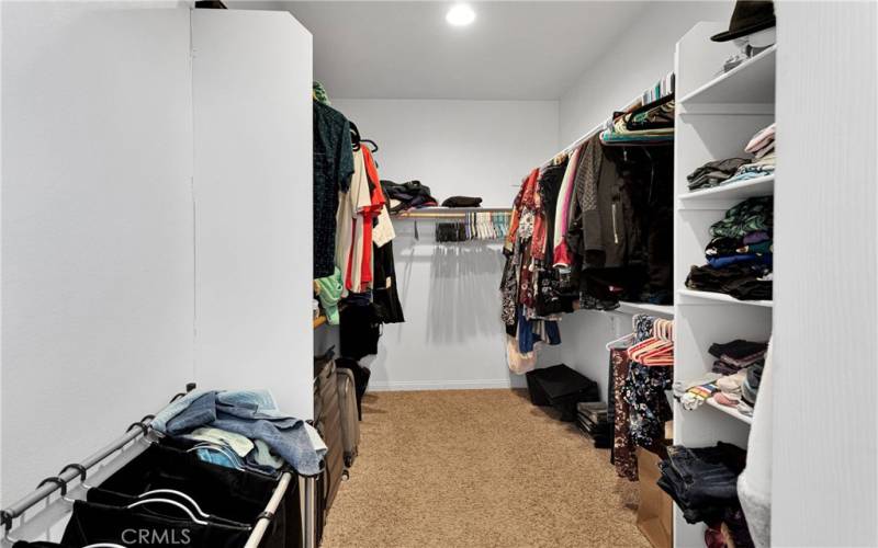 Large walk-in closet in primary bedroom suite.