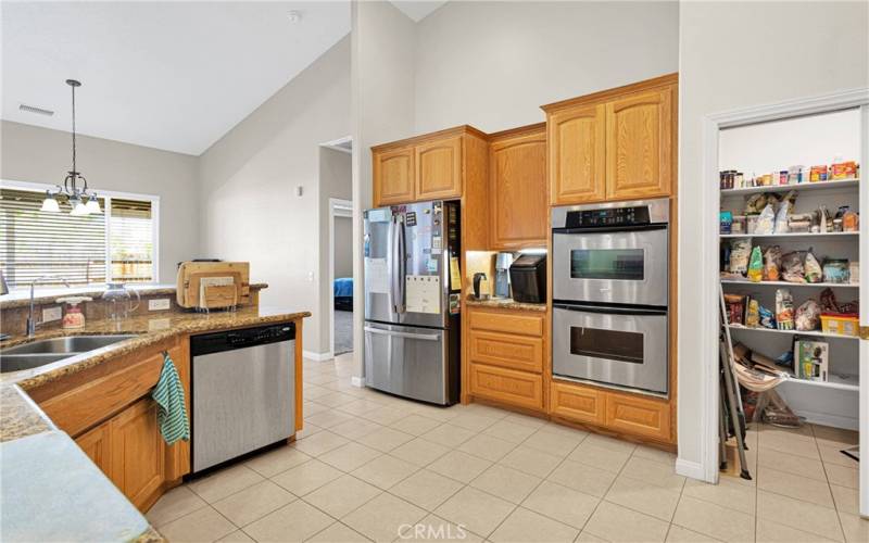 Double wall oven beside the walk-in pantry.