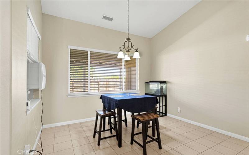 Dining area. Seller has an evaporative cooler installed which can stay or be removed.