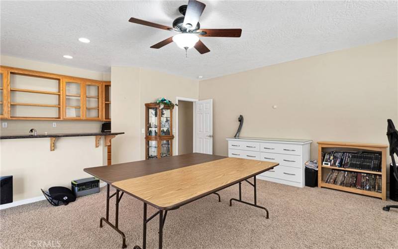 Enormous bonus game room with fully outfitted wet bar is ideal for entertaining or for hobby space. Patio door leads to full span covered patio.