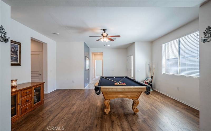 This picture sshows the front door on the right. Hallway leads to the second bedroom, and second bathroom. Door on the left is a closet, then the laundry room, and garage door entry.