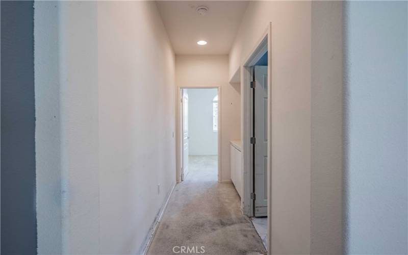 Hallway leads to the blue/white bathroom, hallway cuboards and second bedroom that faces the street and golf course accross the street.