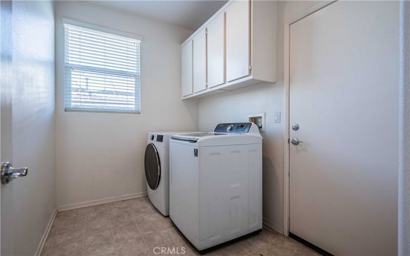 Laundry room is tiled. Washer dryer will convey.