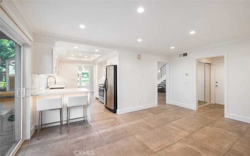 Breakfast bar dividing kitchen from family room with access to outdoor patio.