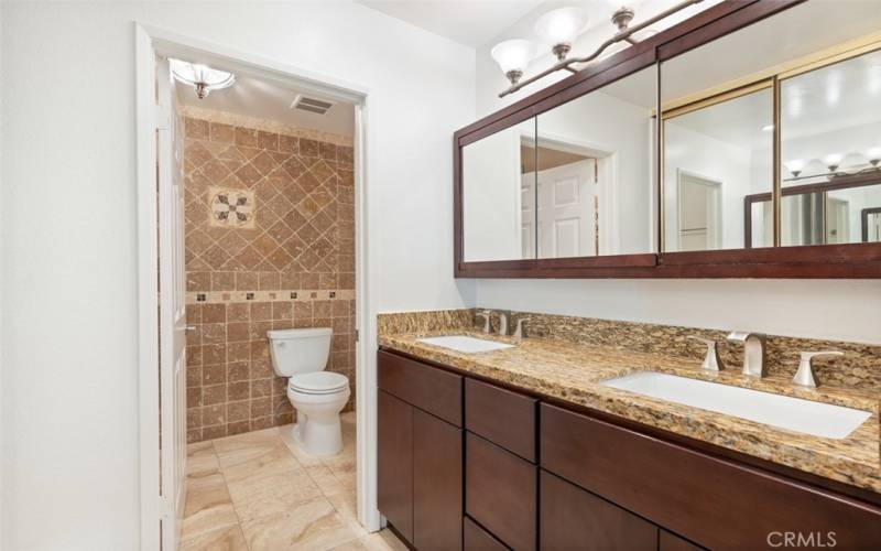 Primary bathroom with upated vanity and separate room with commode and shower for privacy.