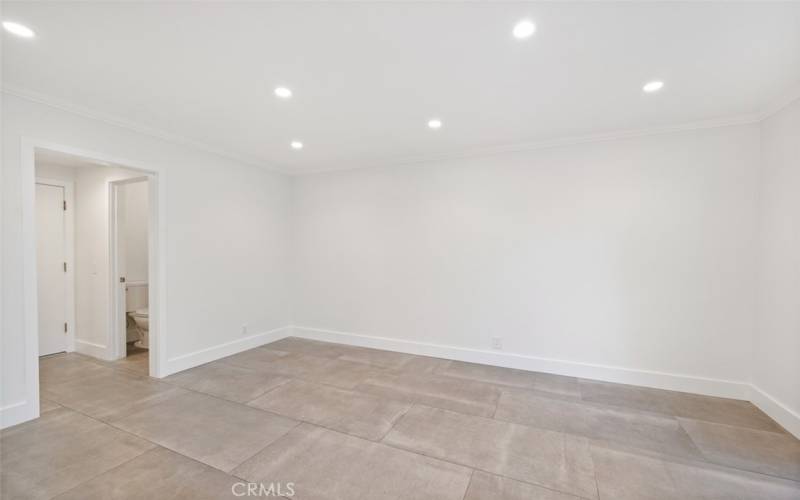 Family room with hallway to powder room and access to attached garage.