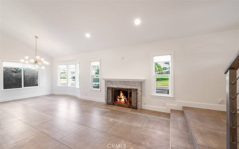 Cozy fireplace with picturesque windows overlooking the park.