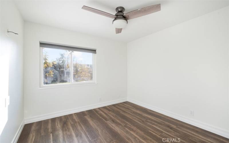 Third bedroom with modern ceiling fan.