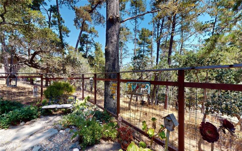 Fully fenced yard with more sitting areas.