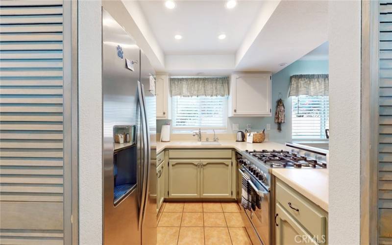 Kitchen with all appliances including pots, pans and dishes.