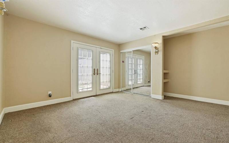 In-law quarters with a private front door entrance and French doors leading to the backyard.