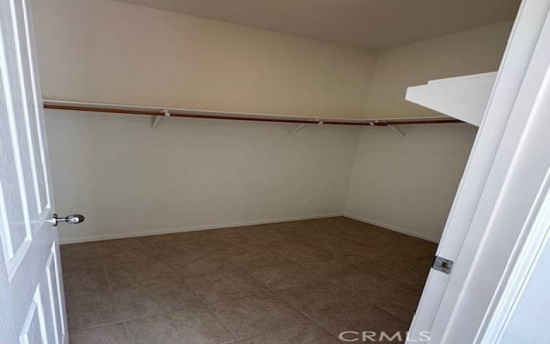 Primary bedroom closet - located in bathroom area