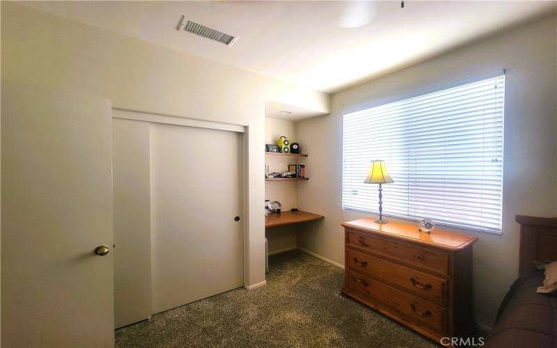 DOWN STAIRS BEDROOM WITH BUILT IN DESK AND SHELVES