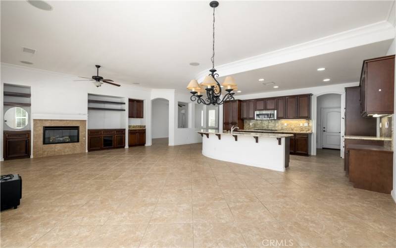 Another view of kitchen and family room with fireplace.