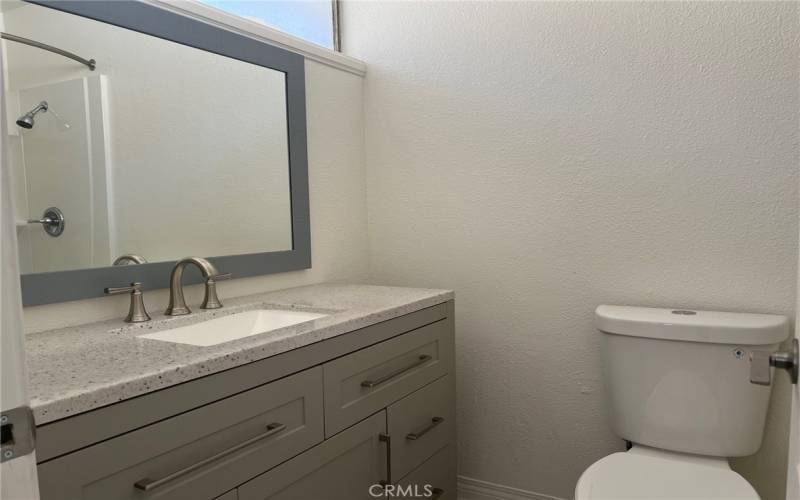 Pretty primary bedroom has a brand new vanity.