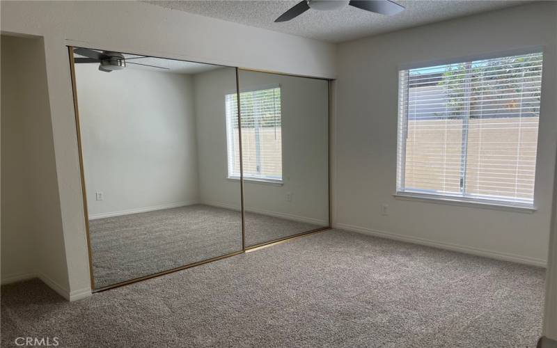 Another large bedroom with spacious closet and ceiling fan.