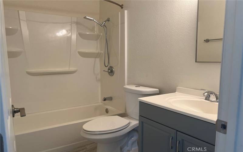 Hall bathroom has a nice vanity and walk in shower.