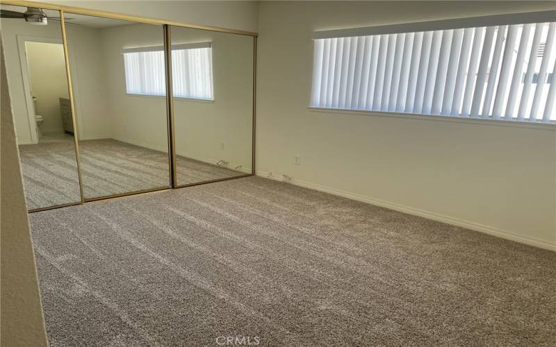 Spacious Primary bedroom has a large closet. and a ceiling fan.