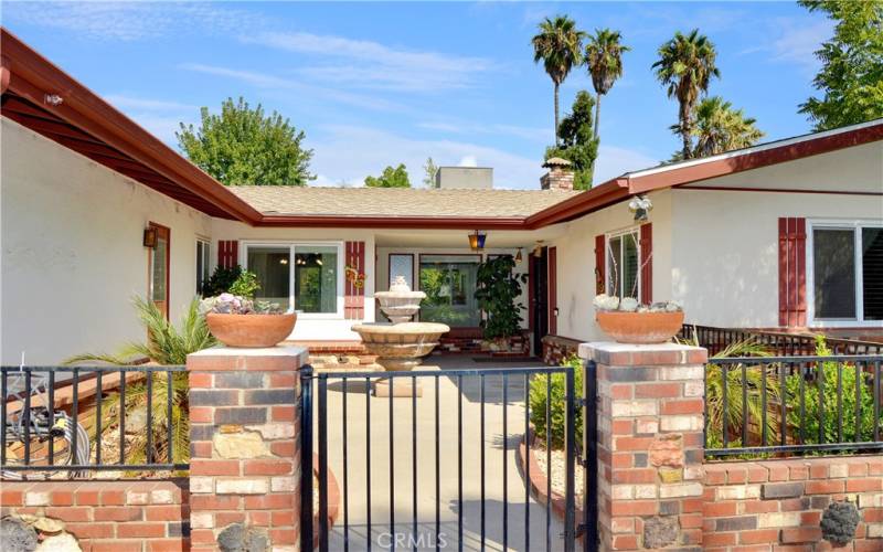 Charming brick and wrought iron gated courtyard is so welcoming!