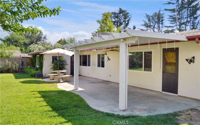 Now back to the big, beautiful backyard with expansive green lawn, a covered patio, two storage sheds, shade trees, roses, and lots of greenery for a relaxing, private space to entertain or just enjoy.