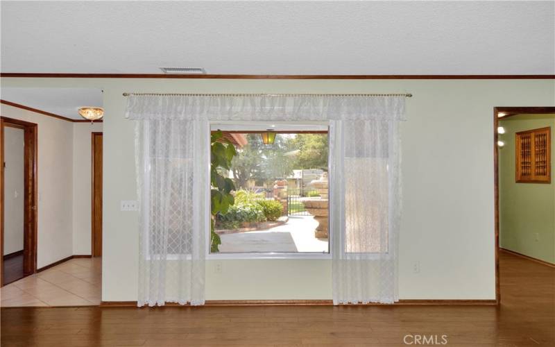 Gorgeous wood flooring, picture windows, and an impressive brick fireplace create a big, beautiful living room