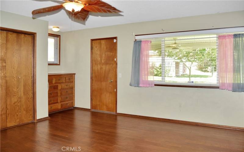 The main bedroom suite offers two built-in dressers, dual closets, access to the backyard covered patio, more gorgeous wood floors, and an ensuite bath we'll re-visit later.