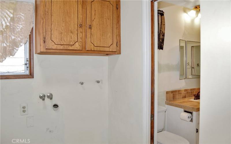 Good-sized laundry room with room for a sink, handy cabinets, and accessible from the garage, kitchen, and main suite bath.