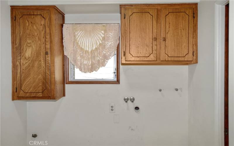 Good-sized laundry room with room for a sink, handy cabinets, and accessible from the garage, kitchen, and main suite bath.