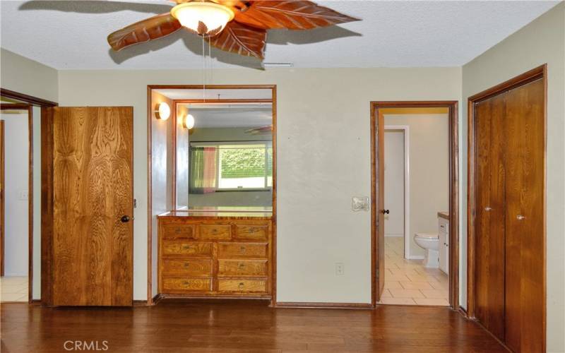 The main bedroom suite offers two built-in dressers, dual closets, access to the backyard covered patio, more gorgeous wood floors, and an ensuite bath we'll re-visit later.