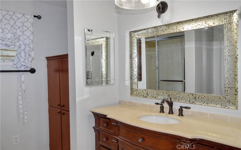 Beautifully upgraded 2nd bath with furniture-style vanity, rain glass shower enclosure, linen closet, tile flooring, and modern fixtures and lighting to make it shine