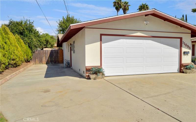 Plenty of space alongside the garage to park an RV with an expansive driveway for multiple cars as well.