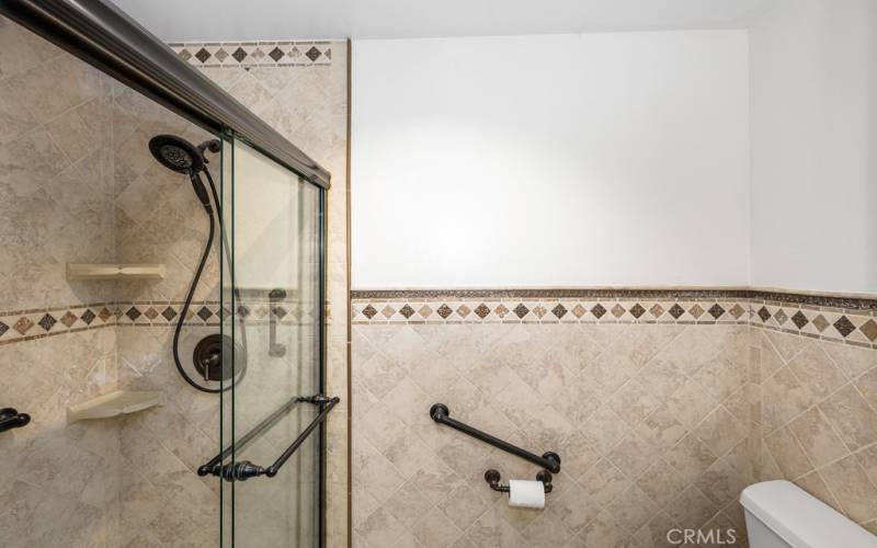 Spa-like shower with dual showerheads and grab bars