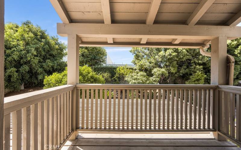 Serene balcony with views of lush greenery and mature trees