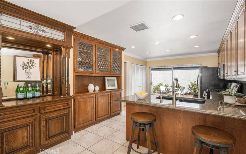 Gorgeous kitchen with wet bar and stainless steel appliances