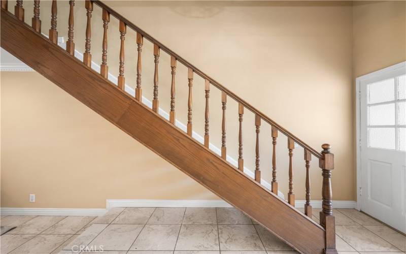 Classic staircase with wooden railings and neutral tones