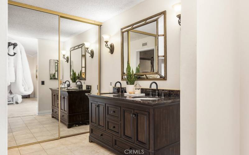 Spa-like primary bathroom with dual vanities and a large mirror