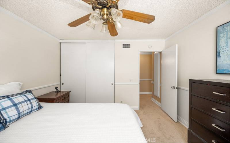 Bright and airy bedroom 2 with a ceiling fan and ample closet space