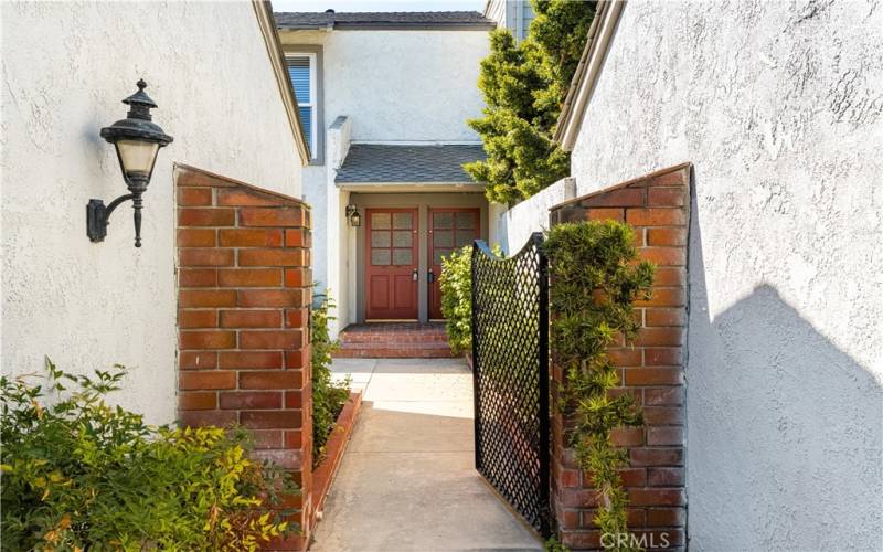 Inviting private courtyard with charming wooden gates and lush greenery