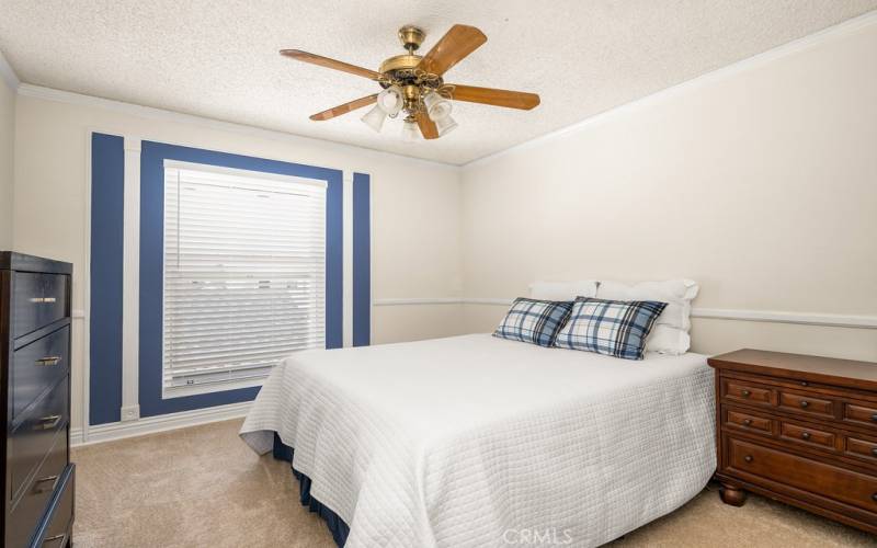 Bright and airy bedroom 2 with a ceiling fan and classic blue accents