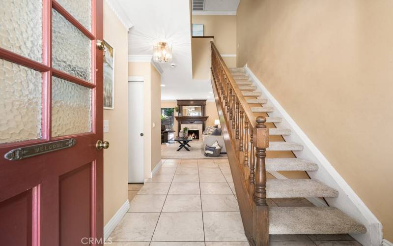 Inviting foyer with classic staircase and ample natural light