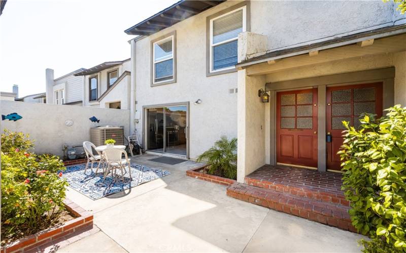 Double door entry into your new home offering an Inviting patio with outdoor living space, perfect for entertaining